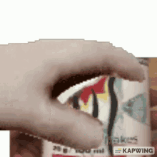 a close up of a person 's hand reaching into a can of food .