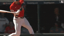 a baseball player is swinging his bat at a baseball