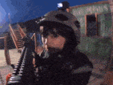 a woman wearing a helmet and holding a gun