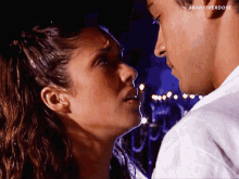 a man and a woman are looking into each other 's eyes with anahioverdose written on the bottom right