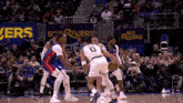 a basketball game is being played in front of a crowd with a banner that says bet rivers