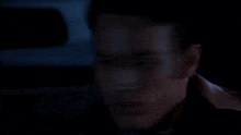 a person is holding a gun in their hand in a dark room