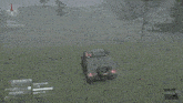 a screenshot of a video game shows a car on its side in a grassy field