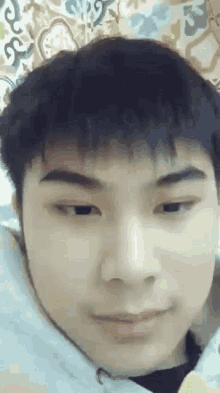 a close up of a young man 's face with a smile on his face .