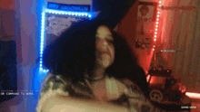a girl is dancing in front of a sign that says " happy halloween "
