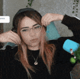 a girl wearing glasses and headphones is sitting in front of a sign that says primer on it