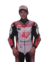 a man wearing a red bull hat and a honda jacket stands in front of a white background