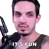 a man holding a microphone with the words " it 's fun " on his face