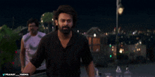 a man in a black shirt with the hashtag pranay_varma on the bottom