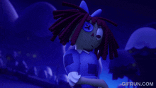 a doll with red hair and a blue button on her eye is shown on gifrun.com