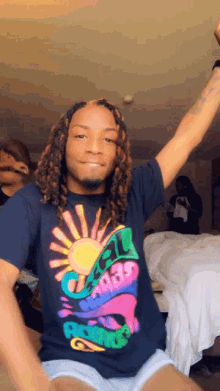 a man with dreadlocks is wearing a t-shirt with the number 21 on it .