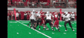 a group of football players on a field with the number 80 on their jersey