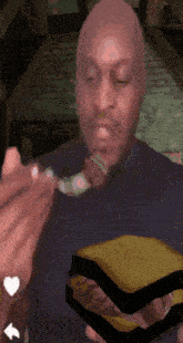 a man is eating a sandwich with a spoon