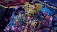 a yellow stuffed animal is surrounded by purple and blue confetti .