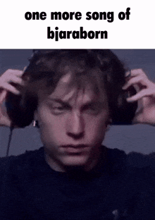 a man wearing headphones with the words `` one more song of bjaraborn '' on it .