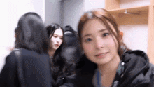 a group of women are standing next to each other in a locker room .