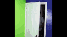 a man is standing in a room with green and blue walls behind a white door .