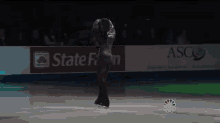 a female figure skater is performing in front of a state farm ad