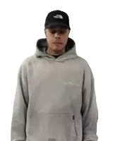 a man wearing a hoodie and a hat with the north face on it