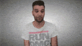 a man wearing a white t-shirt that says run on it