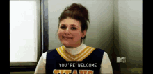 a cheerleader says you 're welcome and smiles