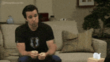 a man is sitting on a couch with a box of tissues in front of him and the hashtag alwayssunnygifs