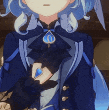 a close up of a person 's chest with a blue pendant
