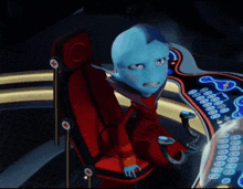 a blue alien is sitting in a red chair in front of a computer screen