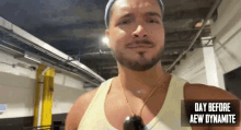 a man with a beard is wearing a tank top with the words day before aew dynamite