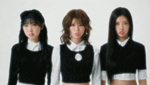 three girls are sticking their tongues out in front of a white wall