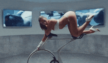 a woman in a white bra is laying on her stomach