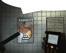 a person is holding a cell phone in front of a poster that says kaniner