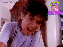 a woman in a blue shirt is screaming with a fantasticlandia logo in the background