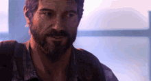 a man with a beard is smiling in a video game