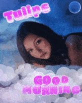 a picture of a woman laying on a cloud with the words tulips good morning