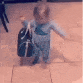 a baby is walking with a duffel bag on his back .