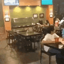 a man sits at a table in a restaurant