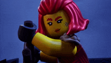 a lego figure with red hair and a red shirt