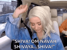 a woman in a car is saying shiva om navah shivaya shiva