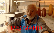 a man in a blue apron is standing in front of a machine with the word pis mand written in red
