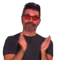 a man with a beard wearing sunglasses is clapping his hands