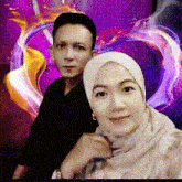 a man and a woman pose for a picture in front of a heart