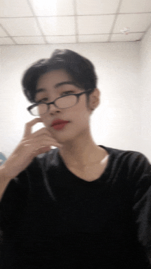 a blurry picture of a person wearing glasses and red lips