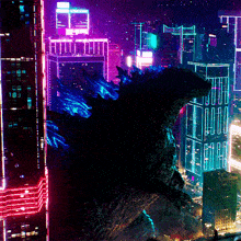 a monster stands in front of a city at night