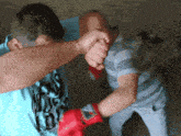 a man wearing a shirt that says boss on it is fighting another man