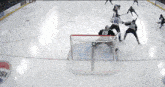 a hockey game is being played in front of a net that says metropcs on it