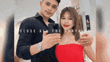 a man and a woman are taking a selfie with their cell phones .