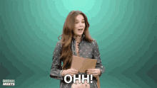 a woman holding a piece of paper with the words ohh written on it
