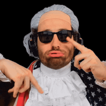 a man wearing a wig and sunglasses is pointing