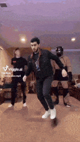 a man in a black jacket is dancing in a living room with other people ..